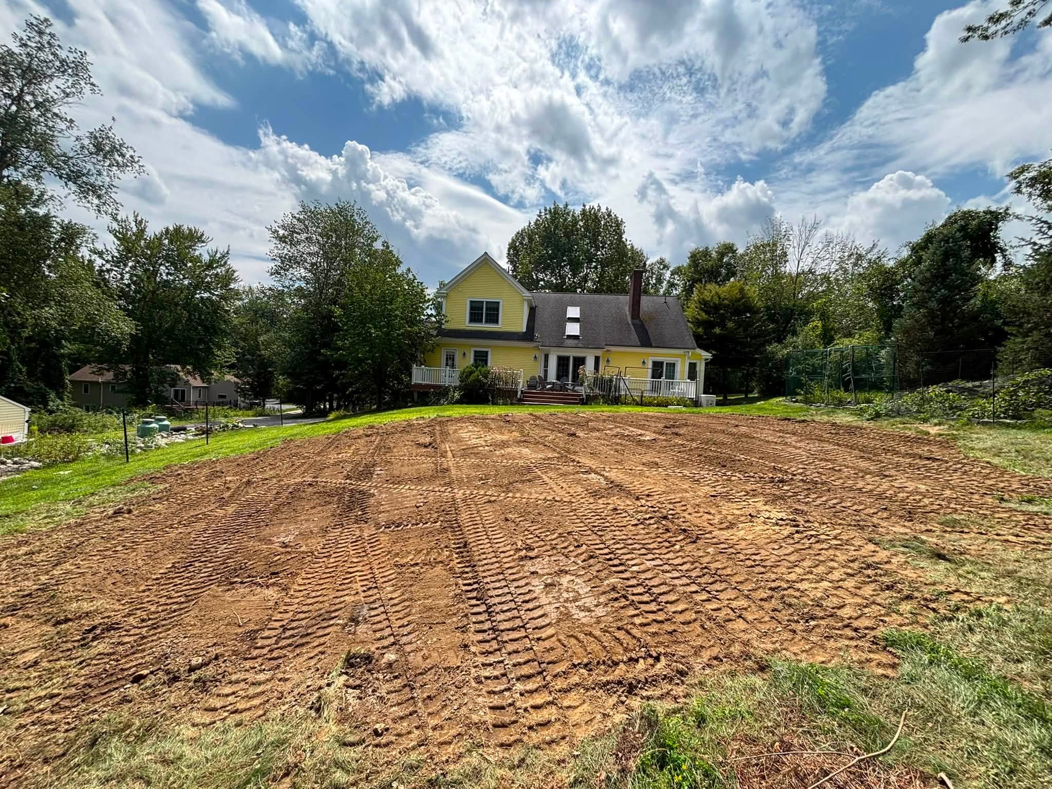 Backyard regraded into smooth gradual slope — Spencer, MA